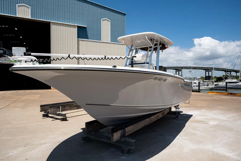 Slide: The Image of 2021 Key West 244 Center Console boat on a dock under a clear blue sky. - 12