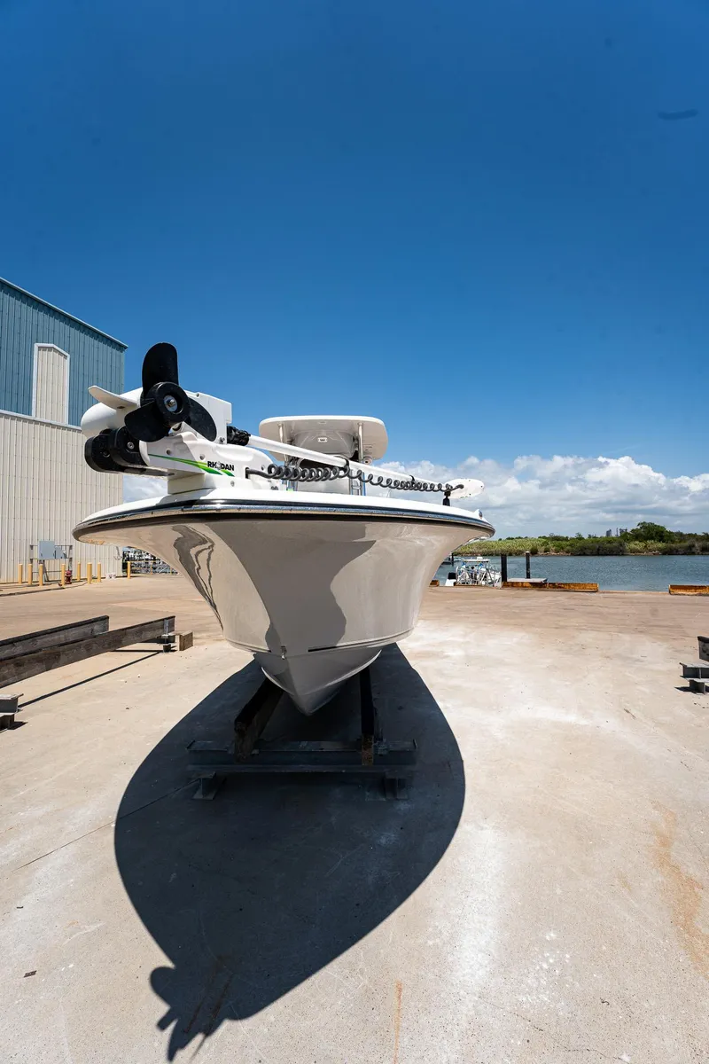 Slide: The Image of 2021 Key West 244 Center Console boat on dock under clear blue sky. - 13