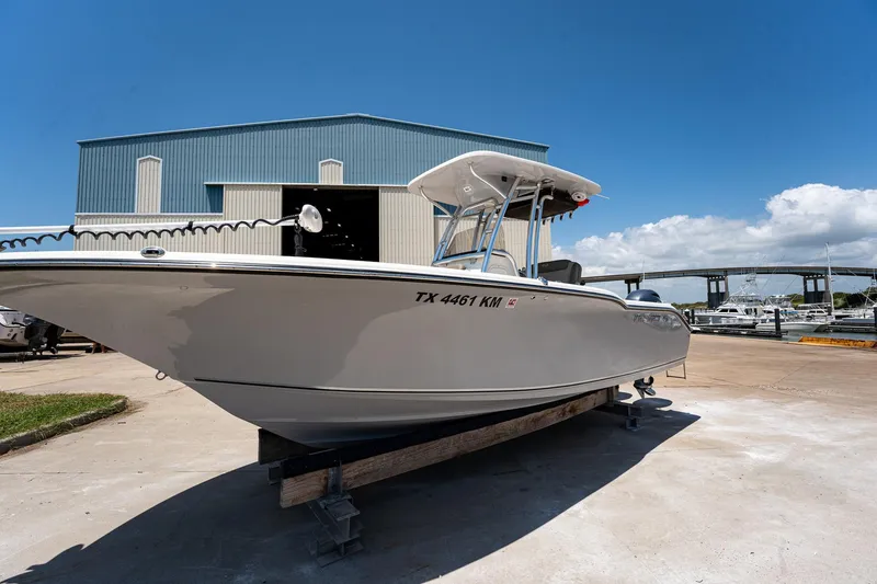 Slide: The Image of 2021 Key West 244 Center Console boat on display outside a blue warehouse. - 15