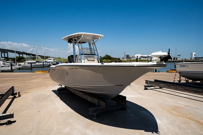 Slide: The Image of 2021 Key West 244 Center Console boat docked at marina under clear blue sky. - 17