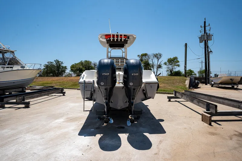 Slide: The Image of 2021 Key West 244 Center Console boat with twin engines on a sunny day. - 2