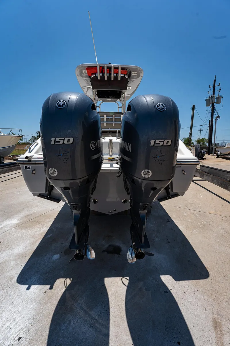 Slide: The Image of 2021 Key West 244 Center Console with dual Yamaha 150 engines, rear view. - 23