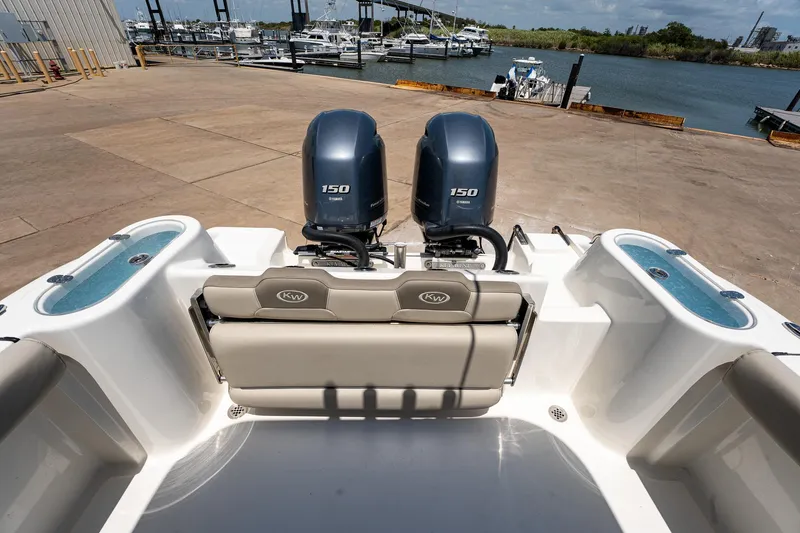Slide: The Image of 2021 Key West 244 Center Console boat with twin 150 horsepower engines at a dock. - 26