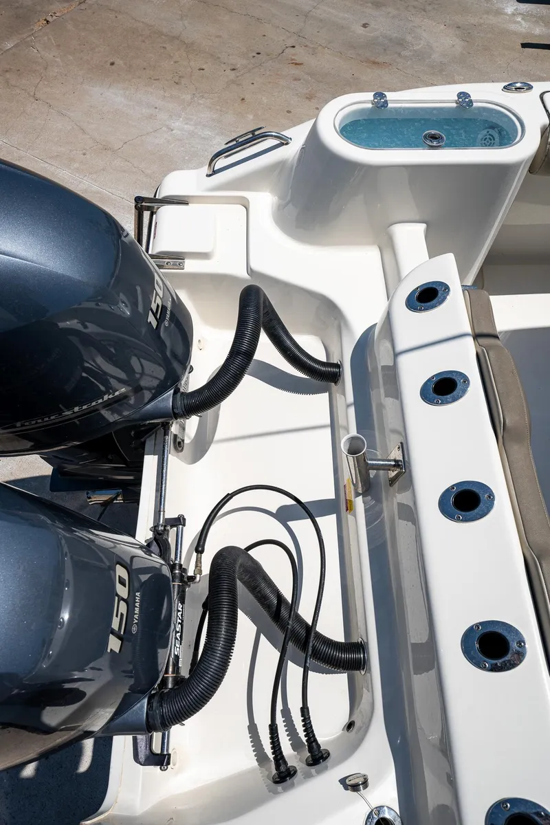 Slide: The Image of 2021 Key West 244 Center Console boat with dual engines and fishing rod holders. - 28