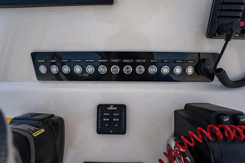 Slide: The Image of Control panel of 2021 Key West 244 Center Console boat with switches and Lenco trim tab display. - 36