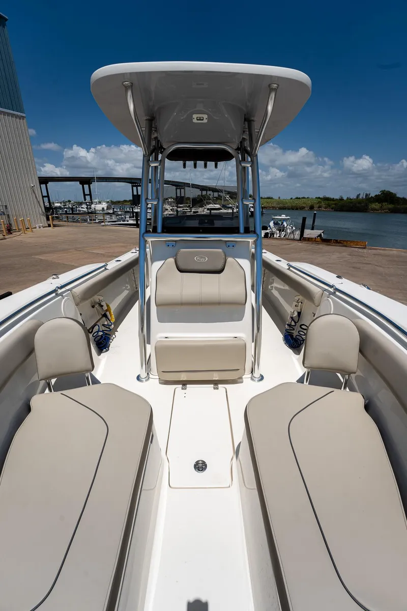 Slide: The Image of 2021 Key West 244 Center Console boat with spacious seating and T-top under clear skies. - 41