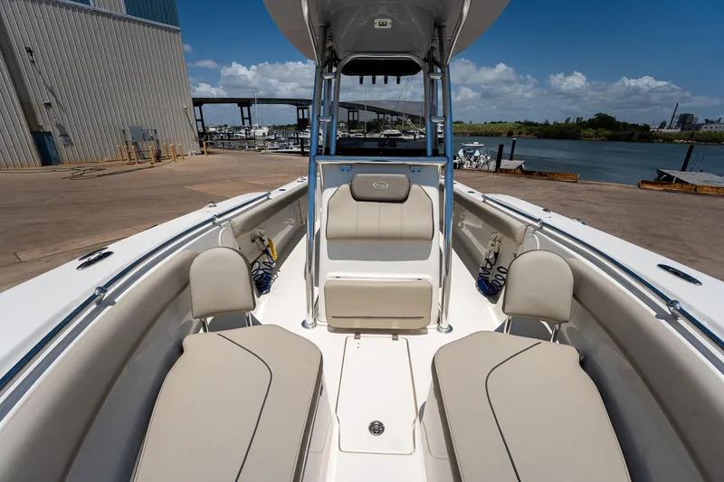 Slide: The Image of 2021 Key West 244 Center Console boat docked at marina, sunny day. - 42