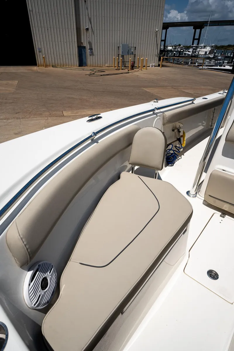 Slide: The Image of 2021 Key West 244 Center Console boat with beige seating and speaker. - 43