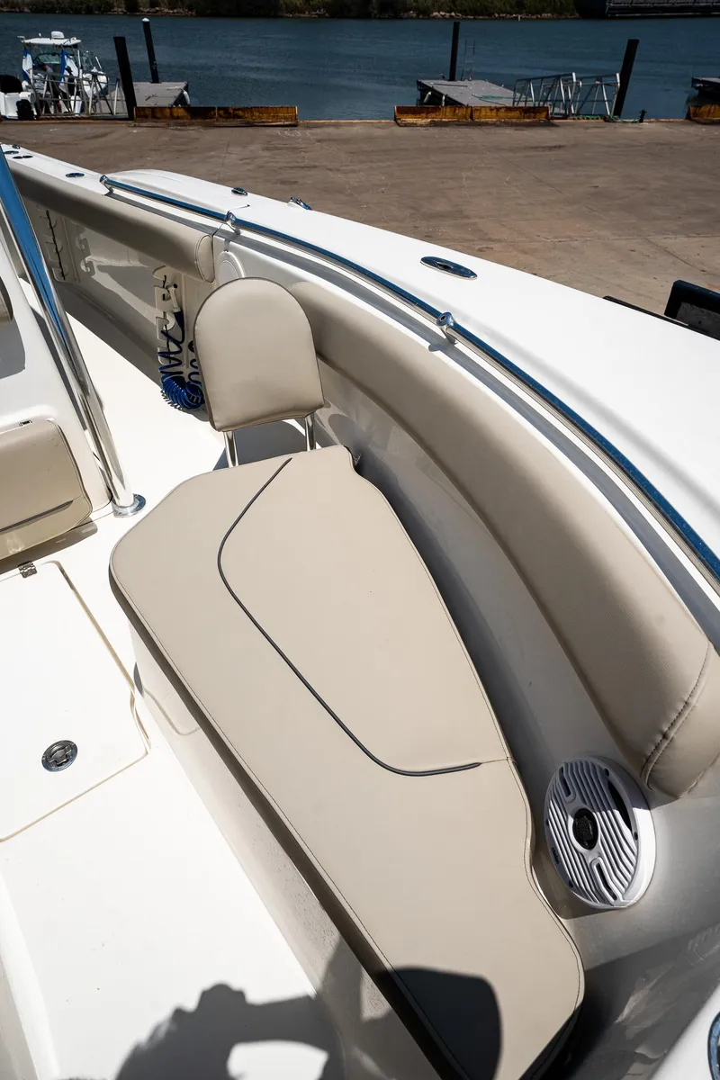Slide: The Image of 2021 Key West 244 Center Console boat interior with beige seating and speaker. - 44