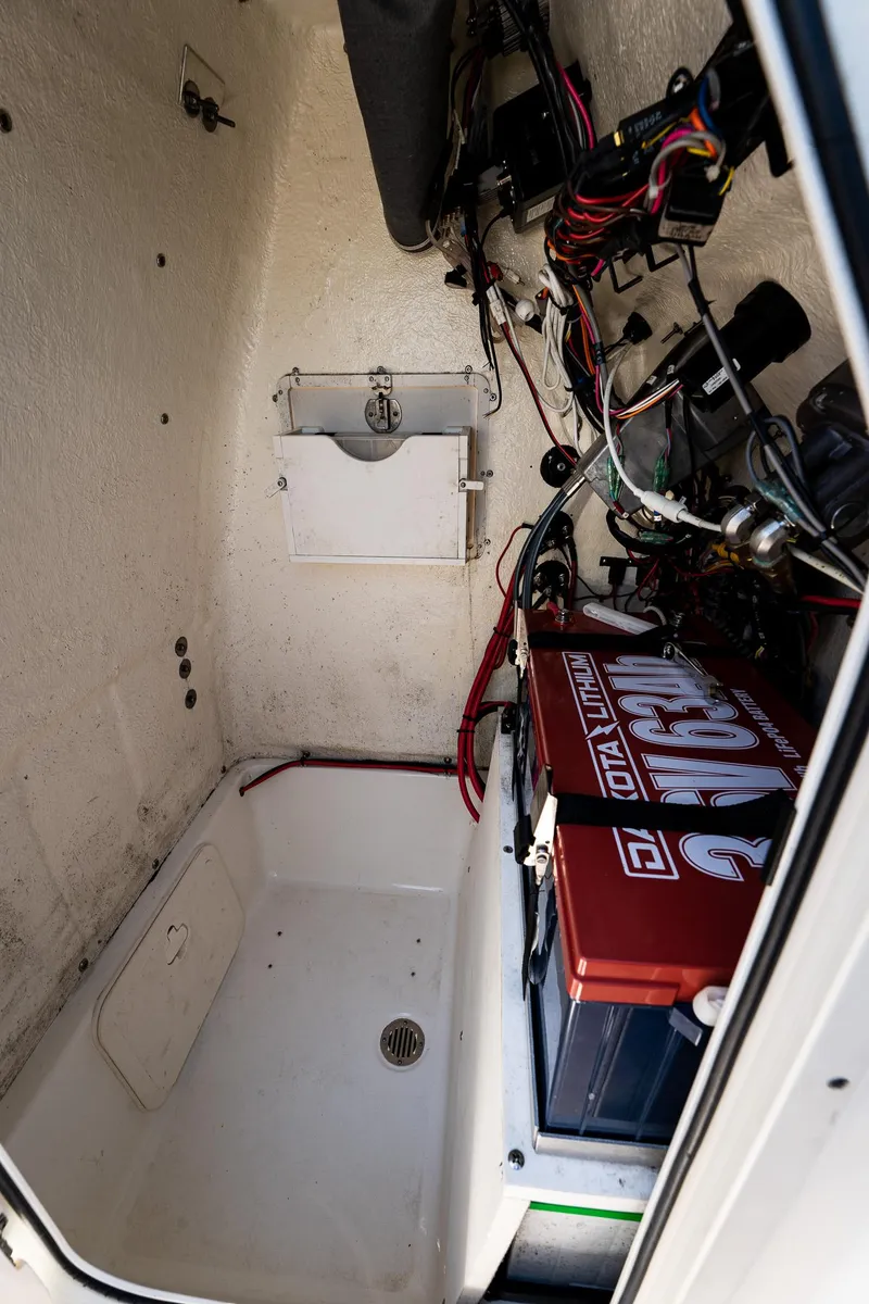 Slide: The Image of 2021 Key West 244 Center Console interior wiring and battery compartment. - 48