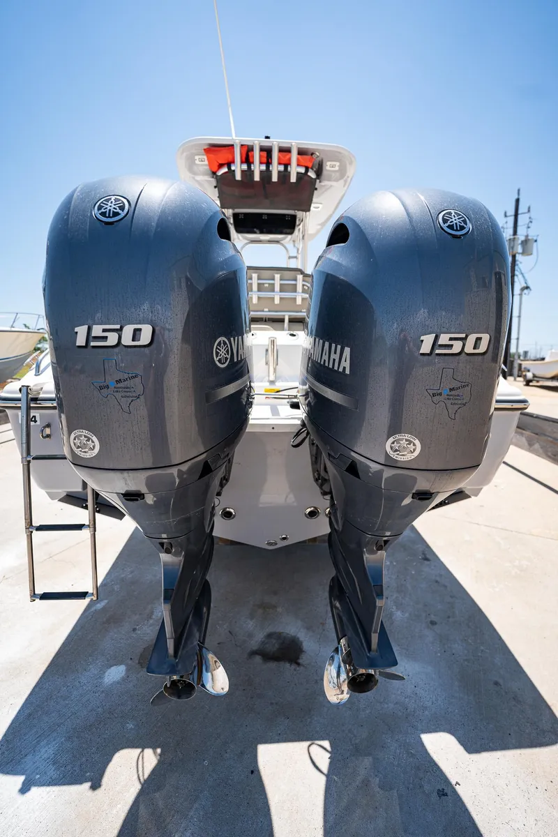 Slide: The Image of 2021 Key West 244 Center Console with dual Yamaha 150 engines, rear view. - 19