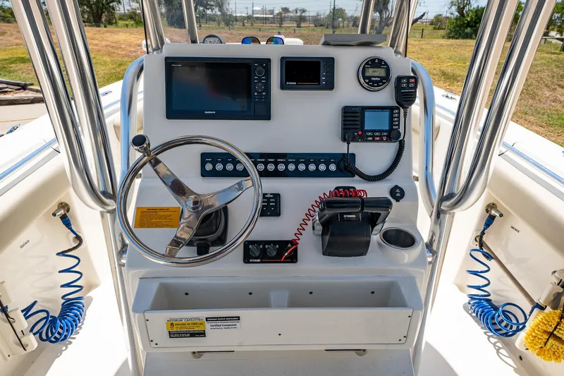 Slide: The Image of 2021 Key West 244 Center Console boat dashboard with steering wheel and navigation controls. - 32