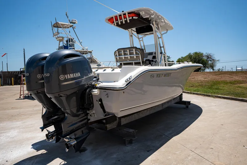 Slide: The Image of 2021 Key West 244 Center Console boat with twin Yamaha engines on a sunny day. - 6