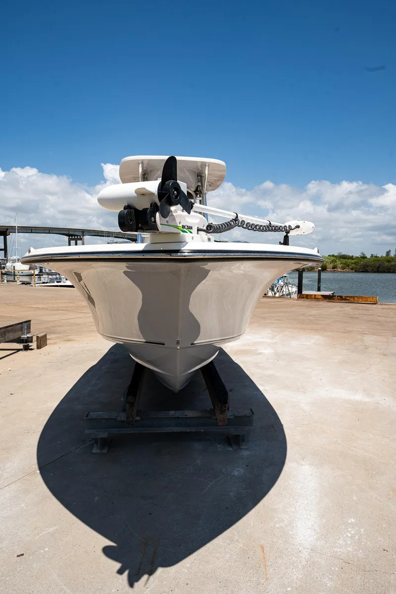 Slide: The Image of 2021 Key West 244 Center Console boat on dock under clear blue sky. - 11