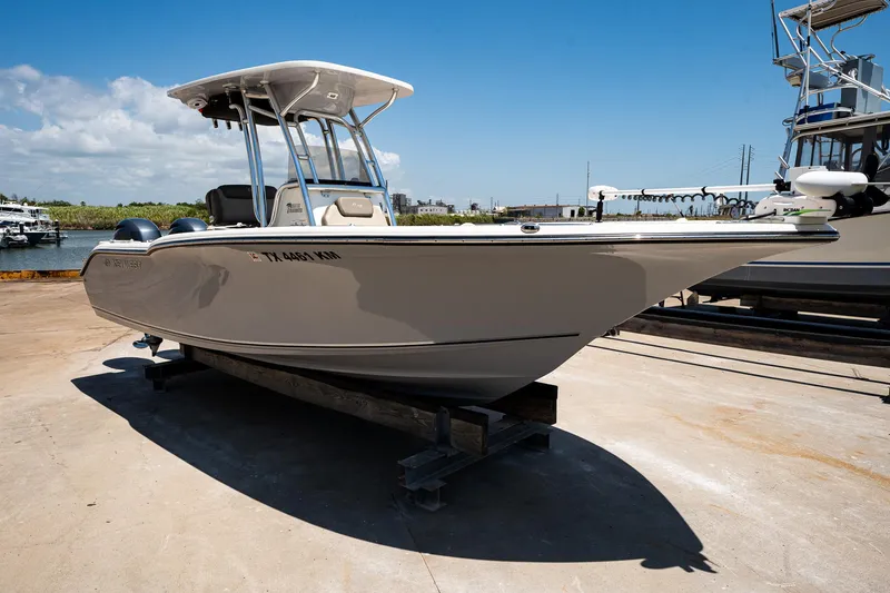 Slide: The Image of 2021 Key West 244 Center Console boat on dry dock under clear blue sky. - 9