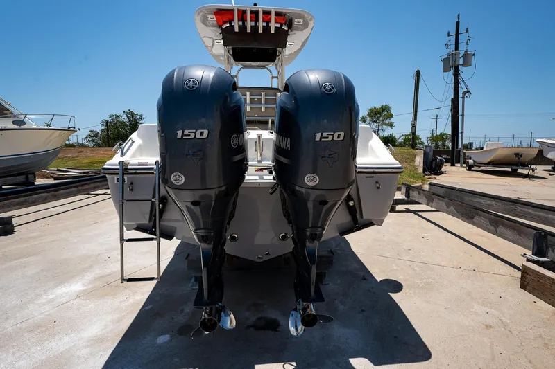 Slide: The Image of 2021 Key West 244 Center Console with twin Yamaha 150 engines, docked outdoors. - 3