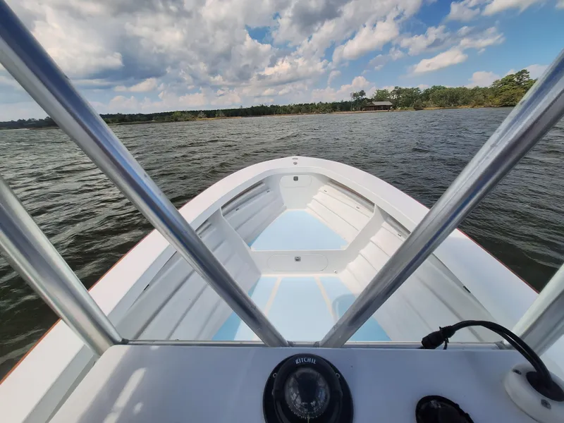 Slide: The Image of View from the bow of a 2008 Custom Carolina boat on a lake. - 10