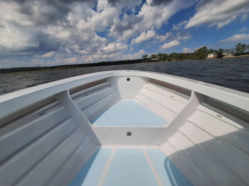 Slide: The Image of 2008 Custom Carolina boat on a lake under a partly cloudy sky. - 11