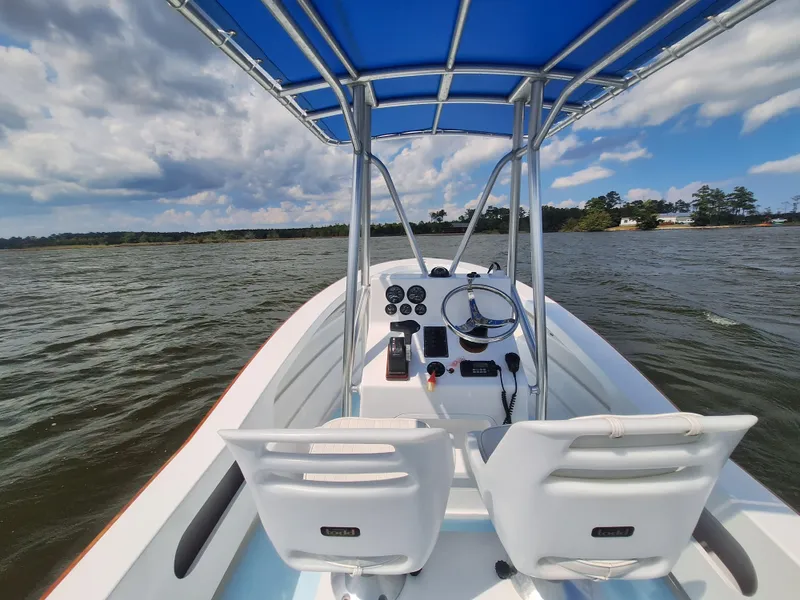 Slide: The Image of 2008 Custom Carolina boat with blue canopy on open water. - 12