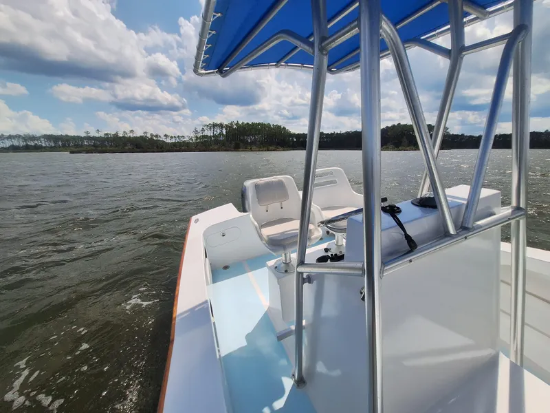 Slide: The Image of 2008 Custom Carolina boat on a lake with blue skies and clouds. - 17