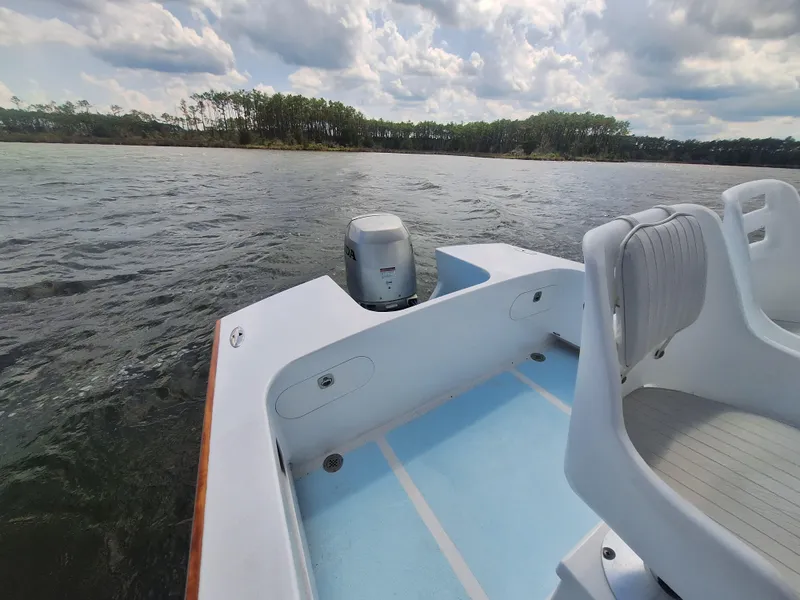 Slide: The Image of 2008 Custom Carolina boat on a lake with scenic forested shoreline. - 19