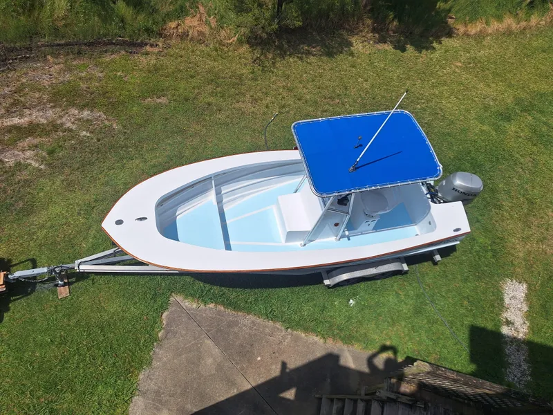 Slide: The Image of 2008 Custom Carolina boat with blue canopy on trailer, aerial view. - 26