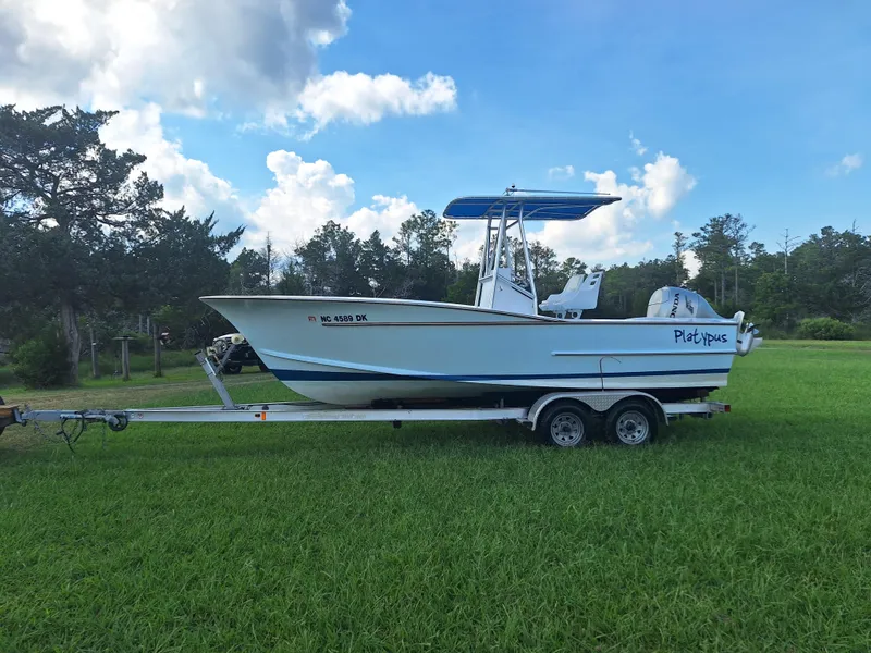 Slide: The Image of 2008 Custom Carolina boat on trailer in grassy field under blue sky. - 28