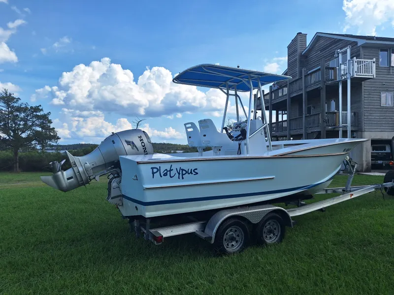 Slide: The Image of 2008 Custom Carolina boat on trailer with Honda outboard motor. - 29