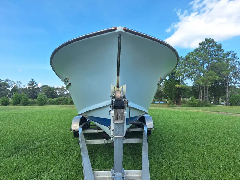 Slide: The Image of 2008 Custom Carolina boat on trailer, parked on grassy field under blue sky. - 31