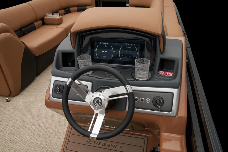 Slide: The Image of 2024 Regency 250 LE3 boat dashboard with steering wheel and touchscreen display. - 36