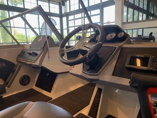 Slide: The Image of 2024 Ranger 1850MS boat interior with steering wheel and dashboard. - 1