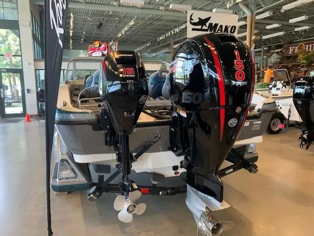 Slide: The Image of 2024 Ranger 1850MS boat with dual Mercury outboard motors displayed indoors. - 8