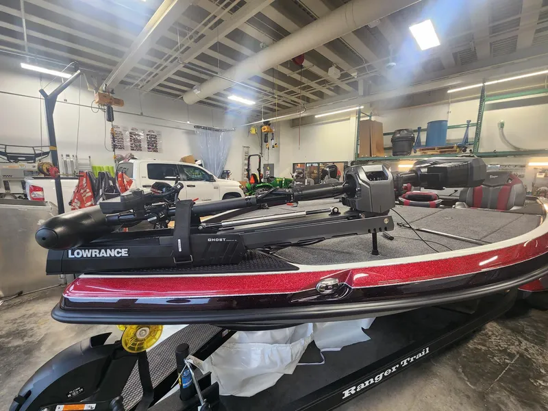 Slide: The Image of 2024 Ranger Z520R Ranger Cup Equipped boat in a workshop with Lowrance equipment. - 3