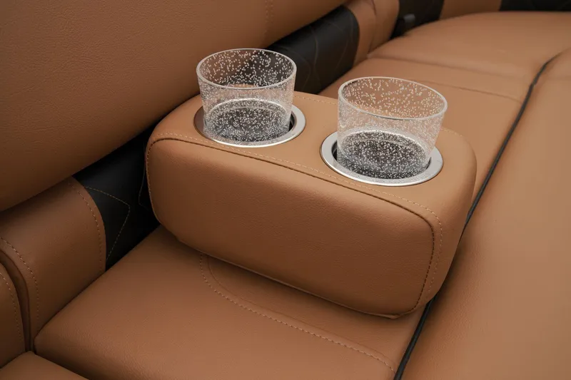 Slide: The Image of 2024 Regency 250 LE3 boat interior with tan leather seats and cup holders. - 24