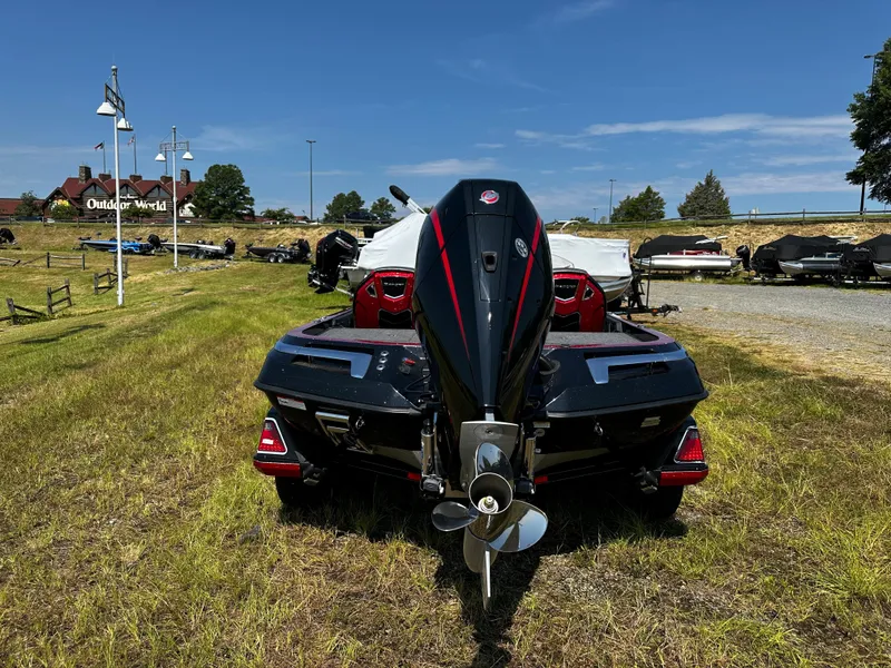 Slide: The Image of 2024 Ranger Z520R Ranger Cup Equipped boat, rear view, parked on grass. - 2