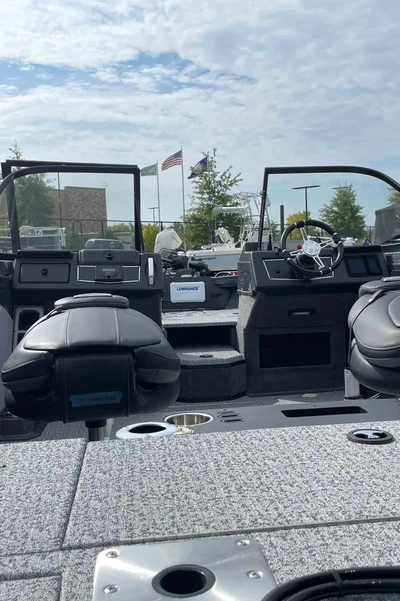 Slide: The Image of 2024 Ranger VX1888 WT boat interior with steering wheel and seating. - 2