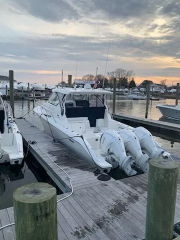 Slide: The Image of 2022 Pursuit OS 355 boat docked at marina during sunset. - 1