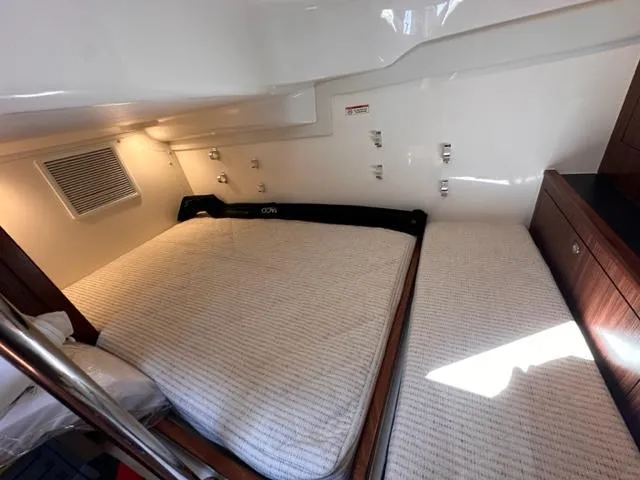 Slide: The Image of 2022 Pursuit OS 355 cabin interior with twin beds and modern amenities. - 12