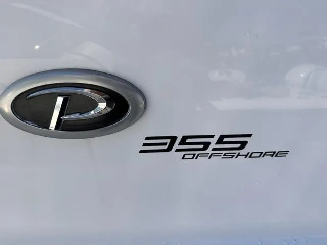 Slide: The Image of Pursuit OS 355 Offshore 2022 logo and model emblem on white surface. - 19