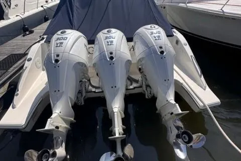 Slide: The Image of 2022 Pursuit OS 355 boat with triple 300 HP outboard engines docked. - 20