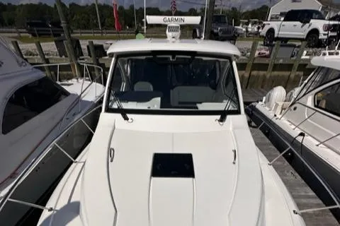 Slide: The Image of 2022 Pursuit OS 355 boat docked at a marina. - 21