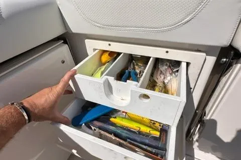 Slide: The Image of Hand opening tackle storage drawer on 2022 Pursuit OS 355 boat. - 25