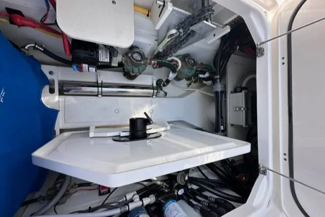 Slide: The Image of 2022 Pursuit OS 355 boat engine compartment with various mechanical components. - 27