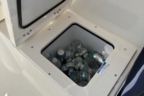 Slide: The Image of Cooler on 2022 Pursuit OS 355 boat filled with drinks and ice. - 28