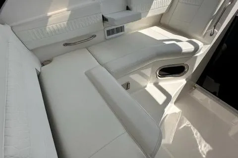 Slide: The Image of Luxurious white seating area on a 2022 Pursuit OS 355 boat. - 29