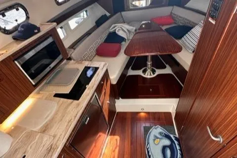 Slide: The Image of 2022 Pursuit OS 355 cabin interior with kitchen and dining area. - 33
