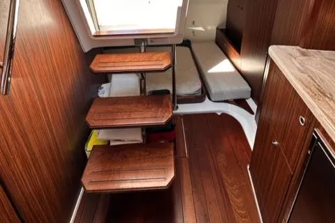 Slide: The Image of 2022 Pursuit OS 355 cabin interior with wooden steps and seating area. - 36