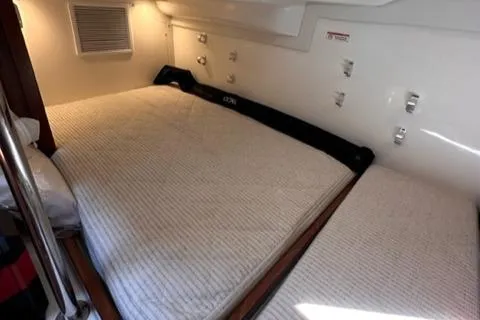 Slide: The Image of Interior cabin bed of 2022 Pursuit OS 355 boat with beige mattress. - 37