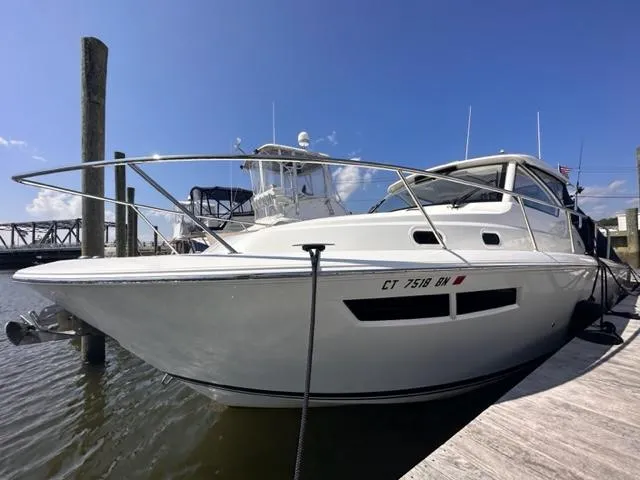 Slide: The Image of 2022 Pursuit OS 355 boat docked at marina. - 4