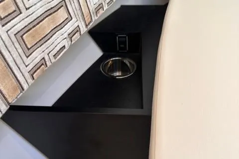 Slide: The Image of 2022 Pursuit OS 355 interior detail with cup holder and patterned upholstery. - 41